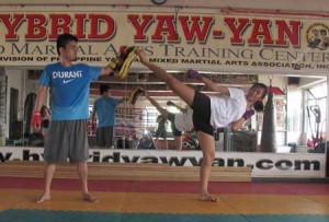 A female fighter practices her kick at the Hybrid Yaw-Yan mixed martial arts gym in Cubao, Quezon City. CONTRIBUTED PHOTO