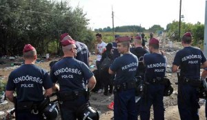 ROAD CLOSED  Hungarian policemen block passage while workers set up fence on the border with Serbia as refugees from Middle Eastern countries approach the Serbia-Hungary border, on foot, near Northern-Serbian town of Horgos, on September 14. For the refugees, the pressure to cross into the EU has increased since Germany reintroduced border controls on Sunday after admitting it could no longer cope with a record influx of migrants. AFP PHOTO