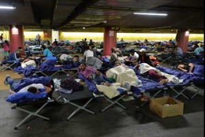 TAKING A RESTRefugees rest in a parking garage in the main rail station in Salzburg, Austria, on Monday. AFP PHOTO