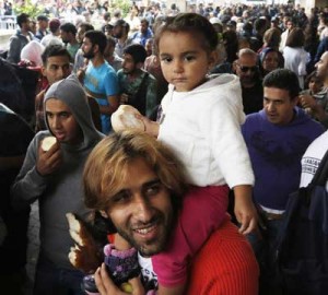 SAFE AT LAST  A migrant carries a child on his shoulders upon arrival at the Westbahnhof railroadstation in Vienna, on Saturday as hundreds of migrants arrive by bus and train from Hungary to continue their journey to Germany. AFP PHOTO