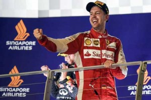 Ferrari’s German driver Sebastian Vettel celebrates his victory on the podium after the Formula One Singapore Grand Prix in Singapore on Sunday. AFP PHOTO