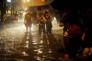 WAter World Residents wade through floodwaters in a street after a sudden heavy downpour in metro manila on Tuesday, stranding thousands of commuters and office workers.  AFP Photo 