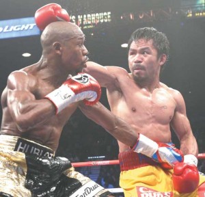 REMATCH? US boxer Floyd Mayweather Jr., (left) and Manny Pacquiao of the Philippines fight during their welterweight unification boxing bout at the MGM Grand Garden Arena in Las Vegas, Nevada on May 2, 2015. AFP FILE PHOTO