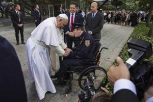 HEALING  Pope Francis shakes the hand of a New York Police Department officer while visiting the 9/11 Memorial plaza in New York on Friday (Saturday in Manila). AFP PHOTO