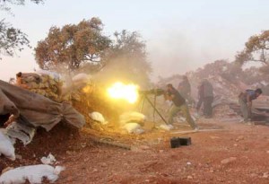 SYRIA’S WAR RAGES ON  A rebel fighter fires a heavy machine gun during clashes with government forces and proregime shabiha militiamen in the outskirts of Syria’s northwestern Idlib province on September 18. AFP PHOTO