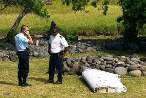 POSITIVE IDENTIFICATION  A file picture taken on July 29 shows a policeman and a gendarme stand next to a piece of debris from an unidentified aircraft found in the coastal area of Saint-Andre de la Reunion, in the east of the French Indian Ocean island of La Reunion. French prosecutors confirmed on September 3 that the wing part was from ill-fated Malaysia Airlines flight MH370, a month after tests on the flaperon began.  AFP PHOTO
