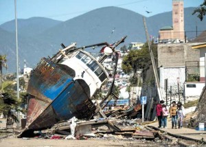 LAND YACHT  A fishing boat that was run aground by a tsunami while moored in the port of Coquimbo, some 445 km north of Santiago, rests on a street after an 8.3-magnitude earthquake struck offshore in the Pacific during the evening of September 17. AFP PHOTO