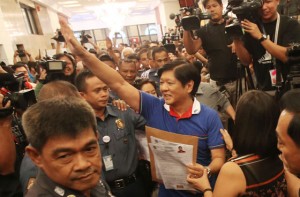 RISING SON Senator Ferdinand ‘Bongbong” Marcos Jr.  waves to his supporters after filing his certificate of candidacy.  PHOTO BY RENE H. DILAN 