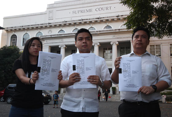 PETITION FOR EXTENSION  Kabataan party-list Rep. Terry Ridon (center) and two youth leaders show copies of the petition they filed at the Supreme Court asking the tribunal to order the Commission on Elections to extend the voters registration until the first week of January 2016.  PHOTO BY RUY MARTINEZ