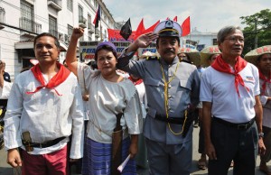 MARCH OF THE REVOLUTIONARIES Members of left-leaning party-list Bayan muna dressed as Spanishcolonial era revolutionaries march towards the office of commission on elections to file their candidacies as party-list representatives at the comelec main office in Manila. AFP Photo 