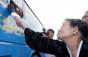 GOODBYE  An elderly South Korean man (L on bus) grabs the hand of his North Korean relative (R) as they bid farewell through the window after a three-day family reunion event at North Korea’s Mount Kumgang resort on October 26. North and South Korean families divided since the Korean War said a tearful final farewell on October 26, wrapping up a rare reunion that was clouded at the last by a maritime border spat. AFP PHOTO