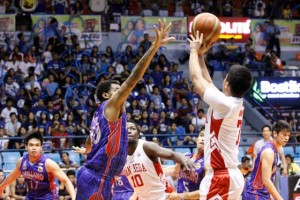 AU’s Dioncee Holts attempts to block a three-point shot by SBC’s Baser Amer during a National Collegiate Athletic Association Season 91 men’s basketball game at The Arena in San Juan City on Thursday. PHOTO BY OSWALD LAVINA