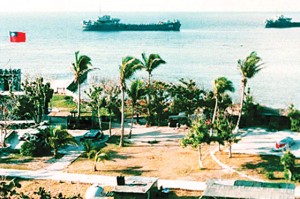 Two Taiwanese warships off the shore of Taiping Island, the largest of the disputed Spratly Islands, with the Taiping military base in the foreground. AFP PHOTO