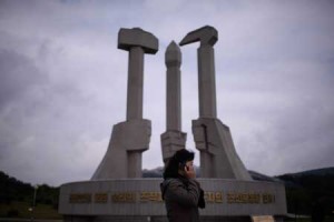 A WHIFF OF CAPITALISM  In this file photo taken on October 11, a woman talks on a mobile phone before the ‘Monument to Party Founding’ in Pyongyang. North Korea’s use of its showcase capital city to promote an image of national success and prosperity has cemented Pyongyang’s reputation as a Potemkin Village boasting leisure facilities that amount to little more than “playgrounds for cadres.” But there are increasing signs that the capital’s political elites are not the only ones able to indulge a taste for consumer goods and a spot of rest and recreation. AFP PHOTO