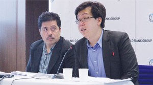 World bank Communications Officer Dave Llorito (left) and Research Analyst Joseph Louie Limkin at the East Asia and Pacific (EAP) Economic Update held at the International Finance Corp. in bonifacio Global City (bGC) on Monday. PHOTO BY ABBY PALMONES 