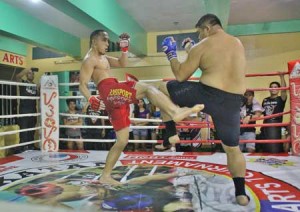 Yaw-Yan Kampilan’s Ricswartz Sibal delivers a leg kick against Savage MMA’s Ronn Merchadesh in the super mega fight of the recently concluded Balikatan 13 Pathway to Greatness. Contributed photo