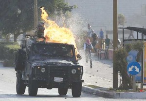 SPREADING CHAOS  An Israeli security forces jeep ignites after Palestinian protesters threw a Molotov cocktail at it during clashes near the Beit El settlement on the outskirts of Ramallah in the West Bank, on October 17. The violence that has raged for more than two weeks prompted a “very concerned” US President Barack Obama to call for calm as the UN Security Council held an emergency meeting a day earlier. AFP PHOTO 