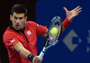 Novak Djokovic of Serbia hits a return against John Isner of the US during their quarter-final men’s singles match at the China Open tennis tournament in Beijing on October 9, 2015. AFP PHOTO