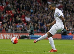 England’s striker Theo Walcott scores his team’s first goal during the Euro 2016 qualifying group E football match between England and Estonia at Wembley Stadium in north London on Saturday. AFP PHOTO