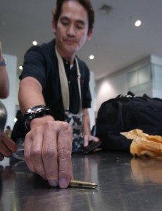 GOTCHA Rey Salado, a traveler bound for Cagayan de oro City, shows the bullet round detected by airport security from his bag at the Ninoy Aquino International Airport Terminal 3. He said the bullet was given to him by a friend in Baguio City. Photo by Rene H. Dilan 