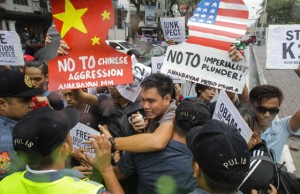 MORE OF THESE AHEAD Policemen block activists who attempted to break into the Gate 7 of Malacañang Palace in Manila. The demonstrators are protesting the holding of the APEC summit in the country. PHOTO BY DJ DIOSINA