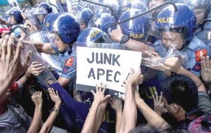 Activists clash with police during a protest against the Asia-Pacific Economic Cooperation (APEC) Summit taking place in Manila. PHOTO BY DJ DIOSINA