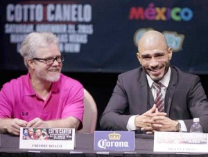 Former WBC Middleweight World Champion Miguel Cotto (left), from Puerto Rico and his trainer Freddie Roach react during a press conference with two time world champion, Saul “Canelo” Alvarez from Guadalajara, Mexico speaks in Las Vegas, Nevada on Thursday. AFP PHOTO