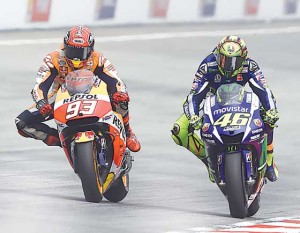 Marc Marquez (right) and Valentino Rossi try to out sprint each other during the Malaysia Grand Prix.