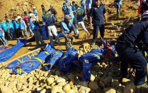 MINING DISASTER  The bodies of miners killed by a landslide are placed on the ground in a jade mining area in Hpakhant, in Myanmar’s Kachin state on November 22. At least 90 people have died in a huge landslide in a remote jade mining area of northern Myanmar, officials said on November 22, as search teams continued to find bodies in one of the deadliest disasters to strike the country’s shadowy jade industry. AFP PHOTO