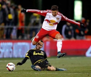 Sal Zizzo No.15 of the New York Red Bulls jumps over Justin Meram No.9 of the Columbus Crew SC while chasing after the ball during the second half on Monday at MAPFRE Stadium in Columbus, Ohio. AFP PHOTO