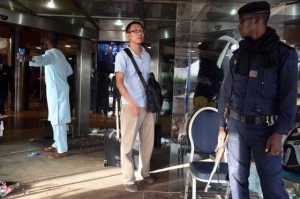 UNDER GUARD A guest leaves the Radisson Blu hotel in Bamako on November 21 after coming to retrieve his belongings, a day after a deadly attack. Investigators in Mali are hunting at least three people suspected of links to the jihadist siege at the luxury Radisson Blu hotel in the capital that left at least 19 people dead. AFP PHOTO