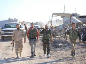 VICTORY MARCH  A group of Syrian pro-government fighters walk in the village of Sheikh Ahmad near the Kweyris military air base, east of the Syrian province of Aleppo on November 10. Syrian regime troops broke a siege by IS fighters at the major military air base that lasted more than a year, and reached government forces inside the base. AFP PHOTO