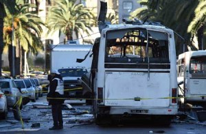 BUS BOMBING IN TUNIS  Tunisian forensic police inspect the wreckage of a bus in the aftermath of a bomb attack on the vehicle which was transporting Tunisia’s presidential guard in central Tunis on November 25. Tunisia’s President Beji Caid Essebsi declared a nationwide state of emergency and a curfew in the capital after the bombing, which killed at least 12 people. AFP PHOTO