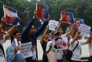 NO FANS OF XI  Protesters shout anti-China slogans as they hold up marked depictions of Chinese president Xi Jinping at Lenin Park in front of the Chinese embassy in downtown Hanoi on November 5, a few hours prior to the arrival of the Chinese leader for a two-day state visit. AFP PHOTO