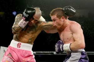 Miguel Cotto (left) and Canelo Alvarez exchange blows during their middleweight fight at the Mandalay Bay Events Center on Saturday (Sunday in Manila) in Las Vegas, Nevada. AFP PHOTO