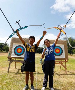 ACE ARCHERS The Manila Times College of Subic (TMTCS) bets Milly Jayvon Persico (left) and ArniLaureen Gabrielle Mendoza (right) hoist their bows after topping the two-day Olongapo City Meet for Archery held atTMTCS Archery Academy in Subic, Zambales. Both will represent the city in the Central Luzon Regional AthleticsAssociation archery meet next year.  PHOTO BY CZEASAR DANCEL