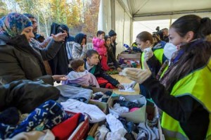 AUSTRIA BRACES FOR REFUGEE ARRIVALS  Volunteers give clothes to refugees and migrants who wait to cross the Slovenian-Austrian border from the Slovenian city of Sentilj, on November 3. Austria’s government moved on November 3 to tighten asylum rules in the EU country. Austria has seen some 400,000 migrants enter the country since September, most of whom travel onwards to Germany or Scandinavia. AFP PHOTO