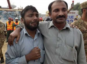 ANXIOUS VIGIL  Pakistani men react as they wait for news of relatives missing under the rubble of a collapsed factory on the outskirts of Lahore on November 5. Pakistani rescuers have pulled 99 people out alive from the rubble of a collapsed factory and are searching for an unknown number of others believed still trapped in a disaster that has killed at least 18, officials said. AFP PHOTO