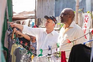 David Sutherland (left), chairman of the Board of International Care Ministries, and Stephen Andoseh, acting director of USAID-Office of Economic Development and Governance, visit one of the 90 communities supported by the program