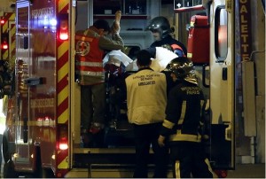 Rescue workers evacuate victims near La Belle Equipe, rue de Charonne, at the site of an attack on Paris on Saturday after a series of gun attacks occurred across Paris as well as explosions outside the national stadium where France was hosting Germany. More than 100 people were killed in a mass hostage-taking at a Paris concert hall and many more were feared dead in a series of bombings and shootings, as France declared a national state of emergency. AFP PHOTO