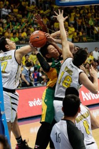 Far Eastern University’s Roger Pogoy (green) goes for a hot against three University of Santo Tomas defenders during the Finals of the University Athletic Association of the Philippines Season 78 men’s basketball. photo by CZAR DANCEL
