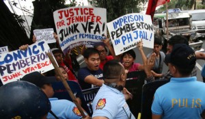  Members of lesbians, gays, bisexuals and transgender group Bahaghari scuffle with policemen during a rally in front of the US Embassy in Manila. PHOTO BY RENE H. DILAN