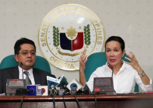 GEARED FOR A LONG BATTLE  Sen. Grace Poe fields questions as her lawyer George Garcia listens during her news conference at the Senate media office on Thursday. PHOTO BY RENE DILAN