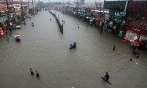 WATERWAY  only the brave tread the Alabang-Zapote road in Las Piñas City in Metro Manila which was under water after almost non-stop rains from Friday evening to Saturday. Photo By DJ Diosina 