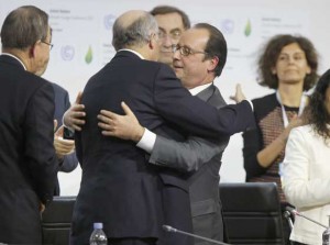 MISSION ACCOMPLISHED  Foreign Affairs Minister and President-designate of COP21 Laurent Fabius (2-L) and France’s President Francois Hollande (C) hug after the adoption of the historic global warming pact at the COP21 Climate Conference in Le Bourget, north of Paris. AFP PHOTO