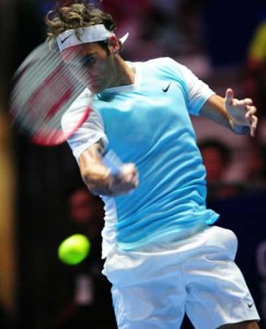 Switzerland’s Roger Federer of Obi UAE Royals hits a return against Switzerland’s Stan Wawrinka of OUE Singapore Slammers during their men’s singles match at the International Premier Tennis League (IPTL) tournament in Singapore on Friday. AFP