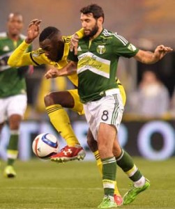 Tony Tchani No.6 of the Columbus Crew SC and Diego Valeri No.8 of the Portland Timbers battle for control of the ball in the first half on Monday at MAPFRE Stadium in Columbus, Ohio. AFP PHOTO