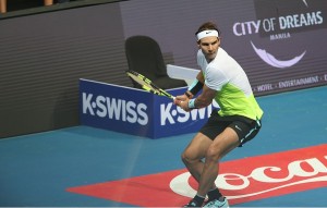 Rafael Nadal delivers an explosive backhand against Thomas Berdych during their match  in the second day of the International Premier Tennis League 2015 at the Mall of Asia Arena in Pasay City on Monday. PHOTO BY RENE H. DILAN