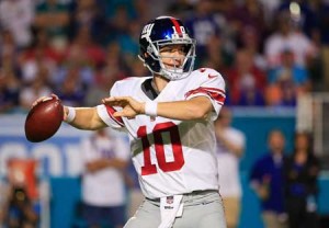 Eli Manning No.10 of the New York Giants throws during the second half of the game against the Miami Dolphins at Sun Life Stadium on Tuesday in Miami Gardens, Florida. AFP PHOTO