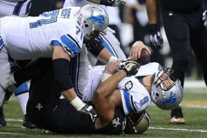 Matthew Stafford No.9 of the Detroit Lions is sacked by Kasim Edebali No.91 of the New Orleans Saints during the first quarter of a game at the Mercedes-Benz Superdome on Tuesday in New Orleans, Louisiana. AFP PHOTO
